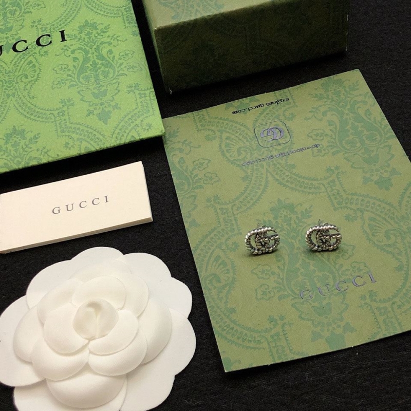 G*u*i earrings